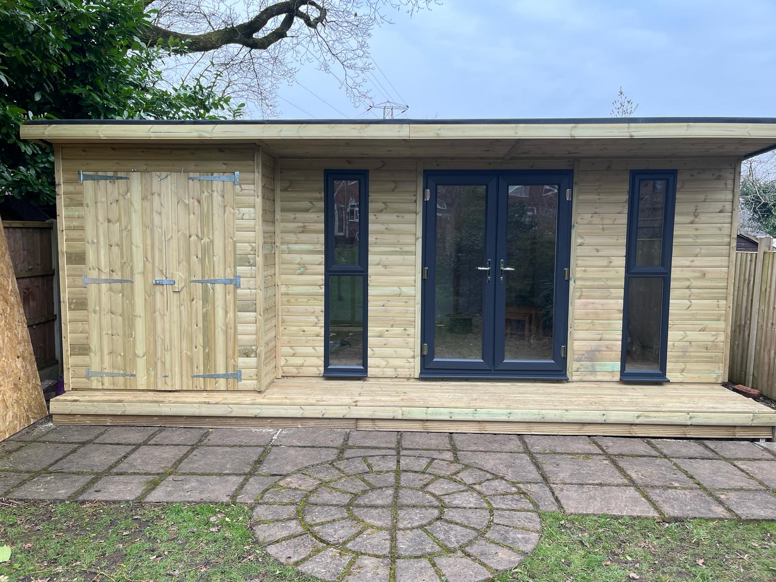Pent summerhouse building in sunny garden