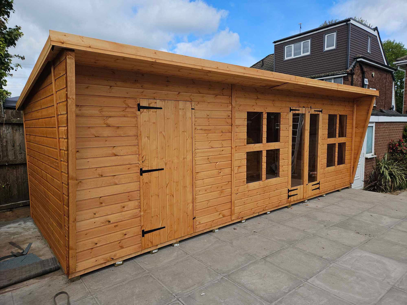 Pent summerhouse building in sunny garden